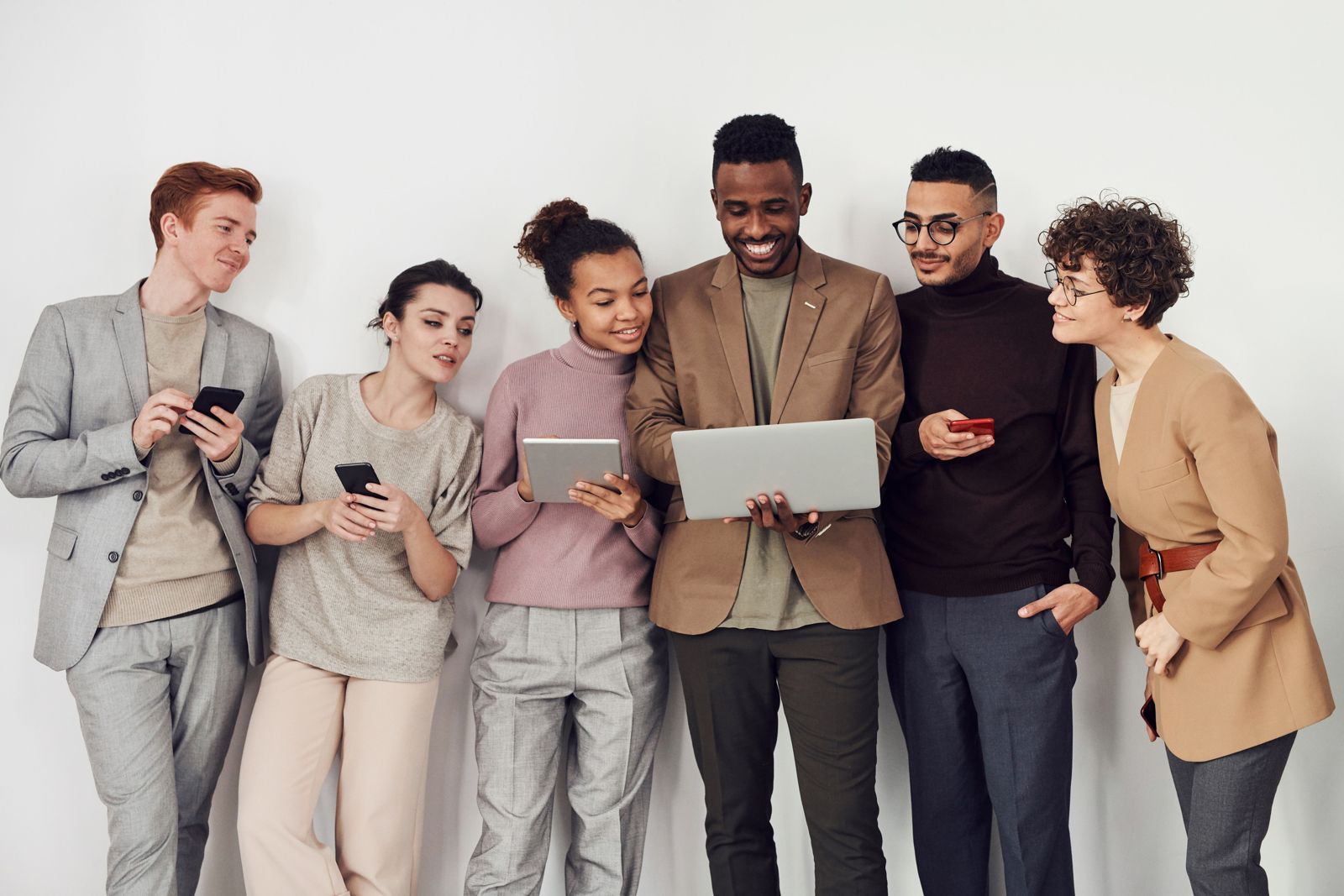 Friends choosing a product together on their phones and a laptop