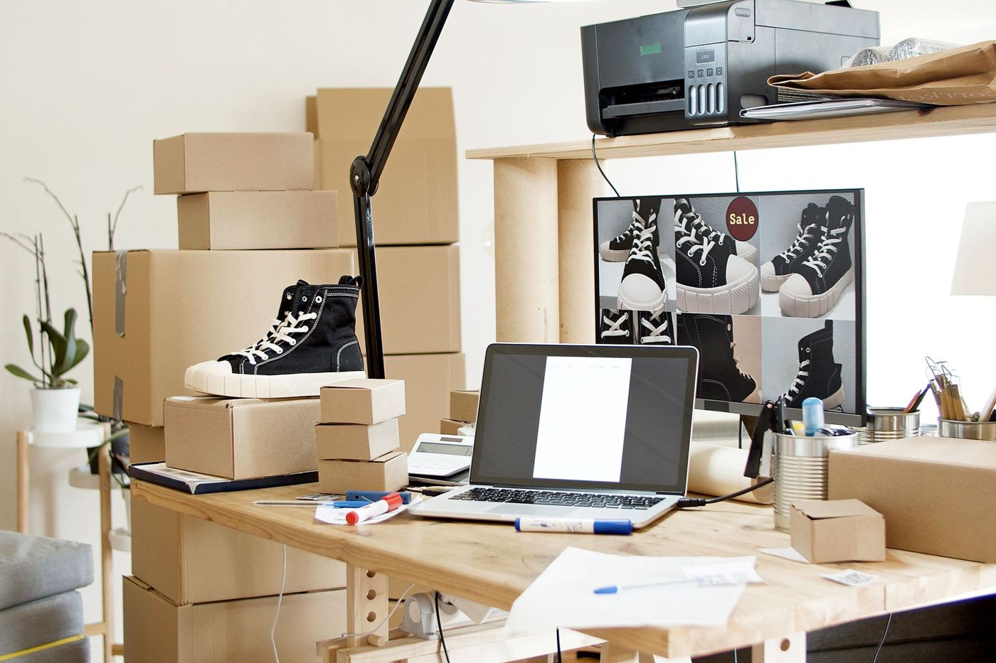 A seller packing parcels at a workshop desk